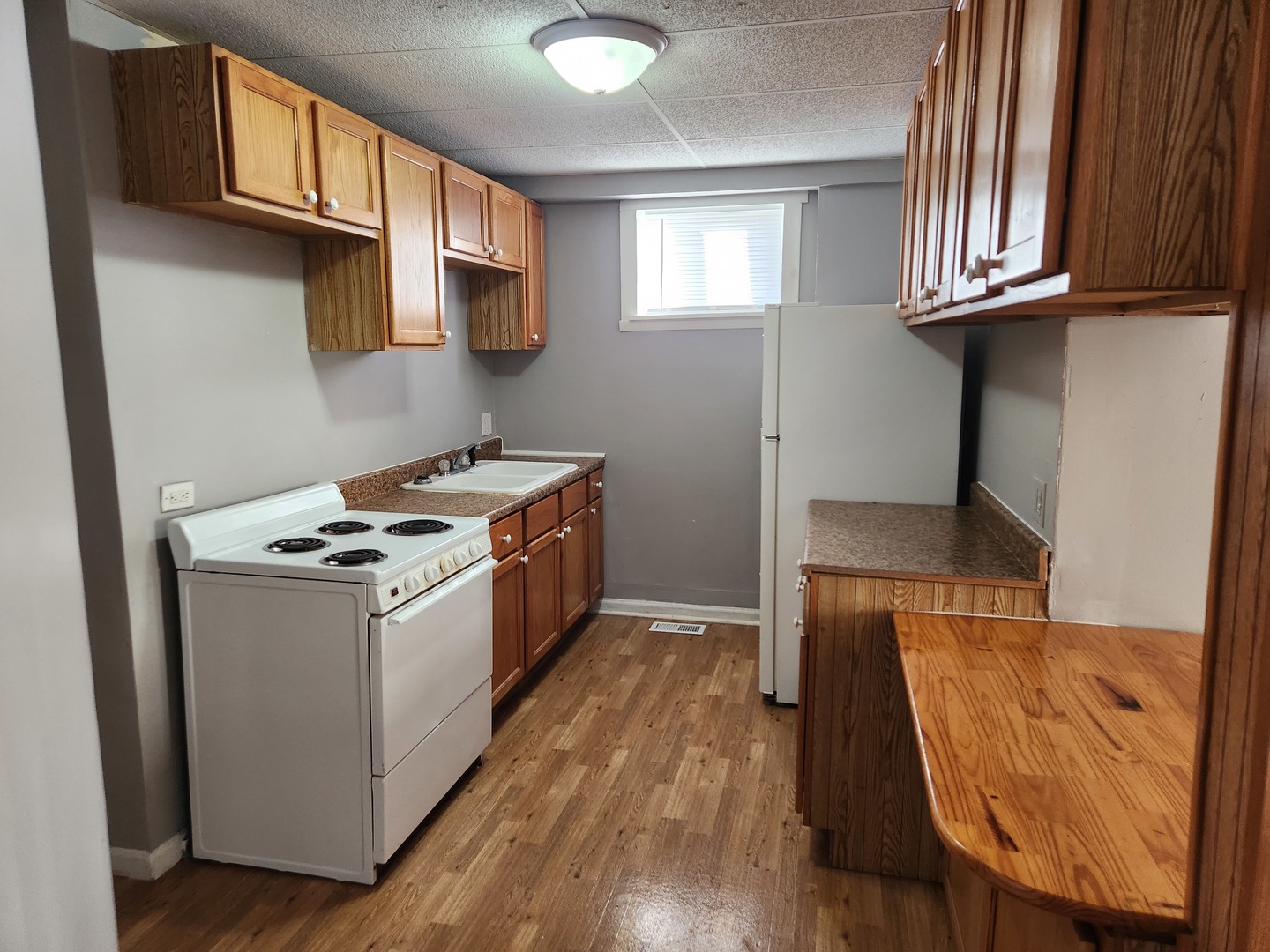 106 West Comanche Avenue, Unit 1E Shabbona, IL 60550 - Photo 4 of 9 a kitchen with stainless steel appliances granite countertop a stove a sink and a microwave