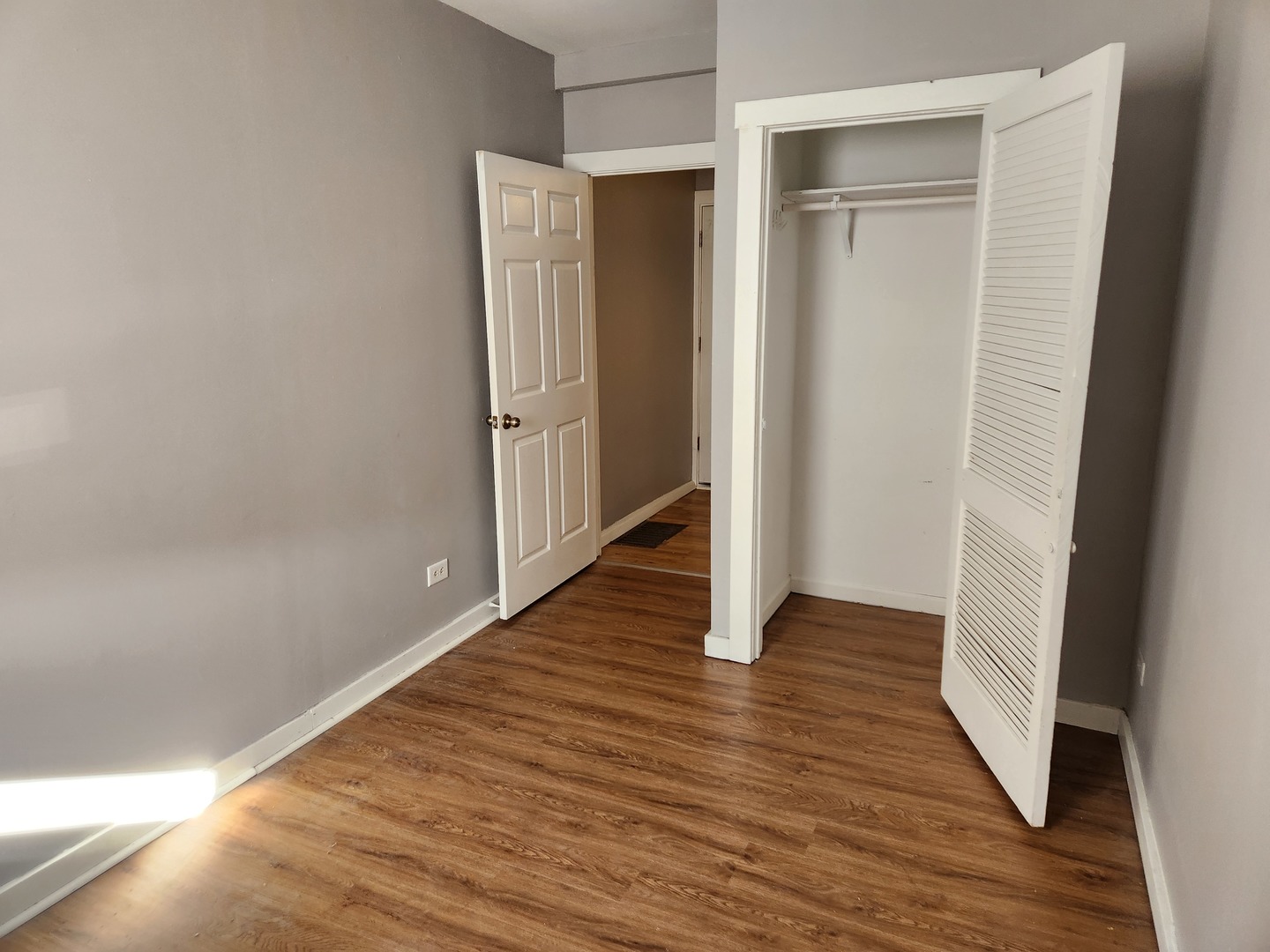 106 West Comanche Avenue, Unit 1E Shabbona, IL 60550 - Photo 8 of 9 a view of wooden floor in an empty room
