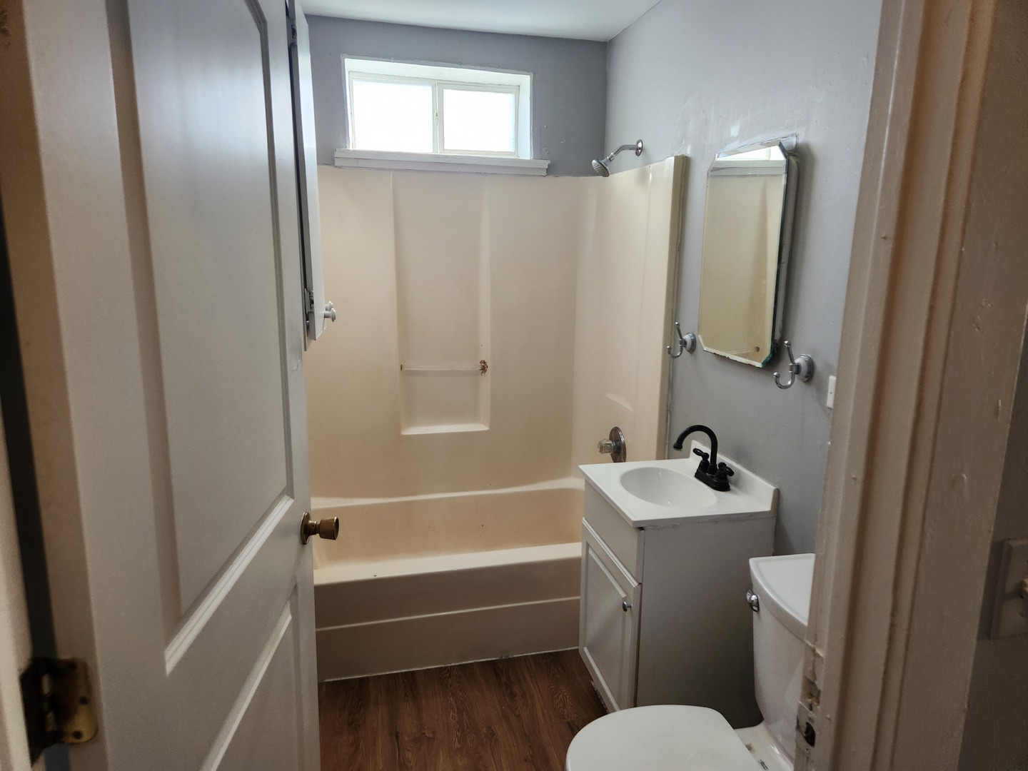 106 West Comanche Avenue, Unit 1E Shabbona, IL 60550 - Photo 9 of 9 a bathroom with a sink and mirror with toilet