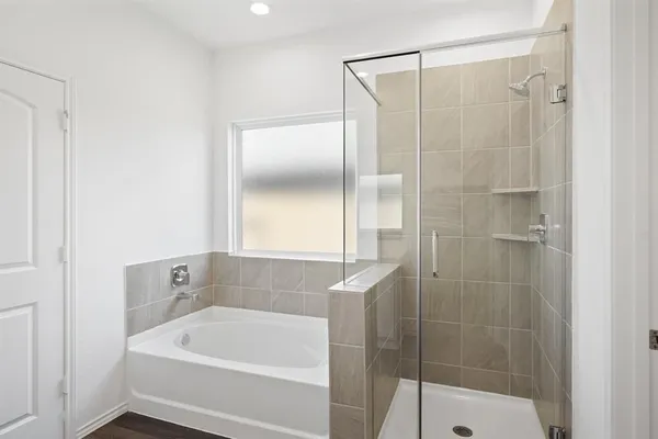 a bathroom with a tub and shower