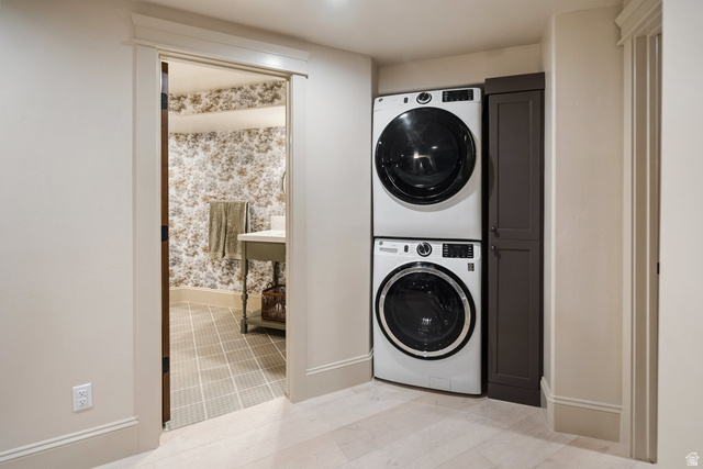 1141 South Oak Leaf Lane Springville, UT 84663 - Photo 108 of 147 Laundry area featuring stacked front-load machines and an adjacent built-in storage cabinet