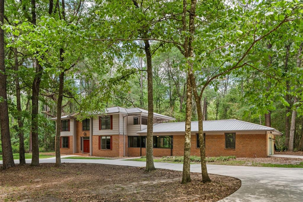 4703 Northwest 124th Street Gainesville, FL 32606 - Photo 5 of 55 a front view of a house with garden