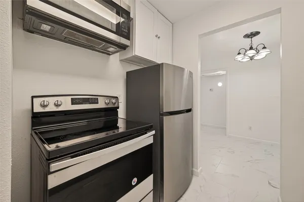 a stove top oven sitting inside of a kitchen