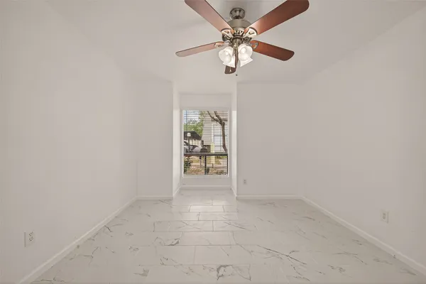 an empty room with a empty space and a ceiling fan