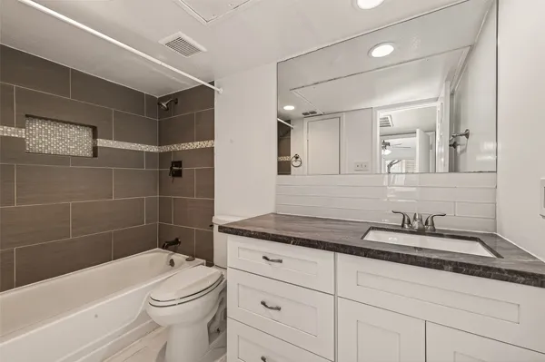 a bathroom with a sink a toilet and bathtub