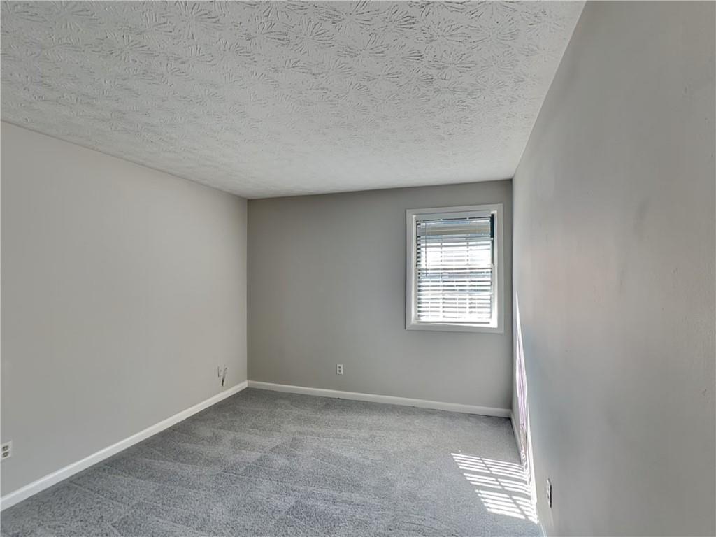 1150 Rankin Street, Unit 3H Stone Mountain, GA 30083 - Photo 14 of 16 an empty room with a window