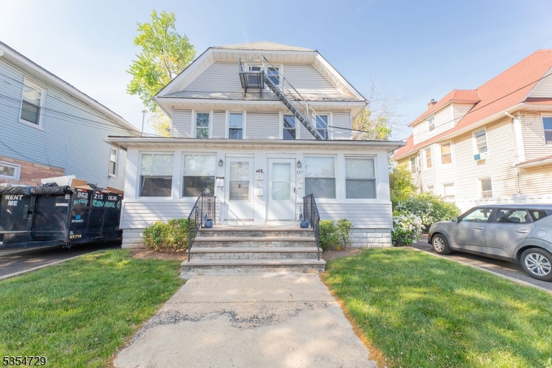 157 Virginia Street Hillside, NJ 07205 - Photo 1 of 37 a front view of a house with a garden and plants