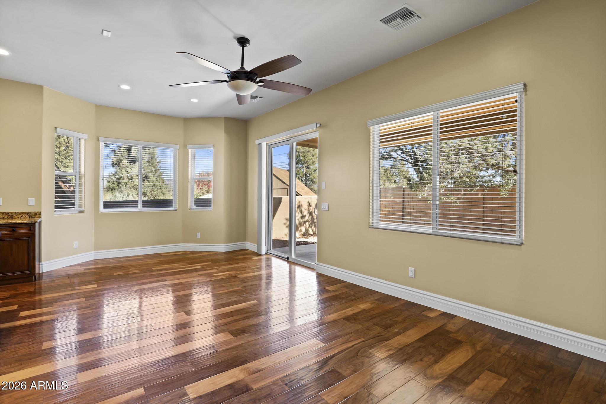 7705 Caballero Road Payson, AZ 85541 - Photo 11 of 43 a view of an empty room with wooden floor and a window