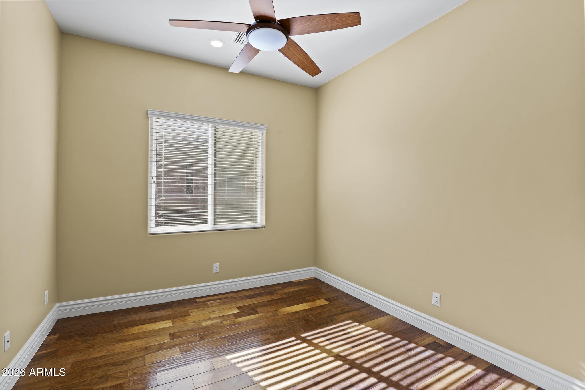 7705 Caballero Road Payson, AZ 85541 - Photo 15 of 43 an empty room with wooden floor fan and windows