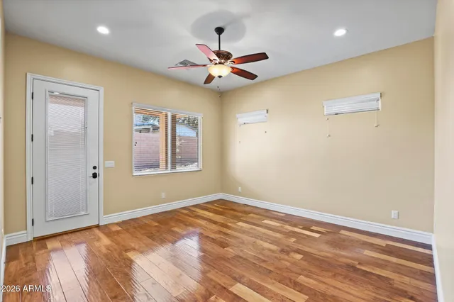 a view of empty room with wooden floor