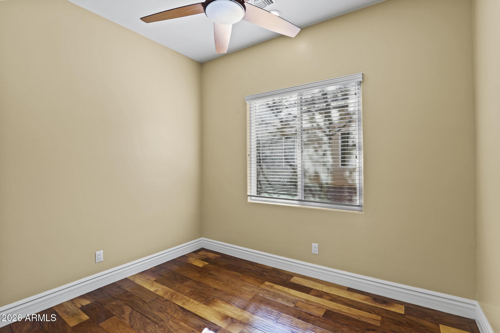 7705 Caballero Road Payson, AZ 85541 - Photo 16 of 43 a view of an empty room with wooden floor and a window