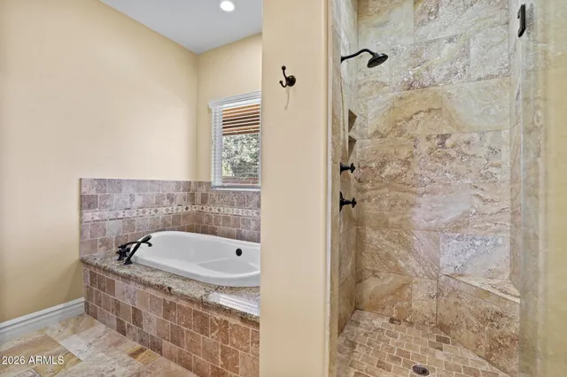 a bathroom with a bathtub and shower