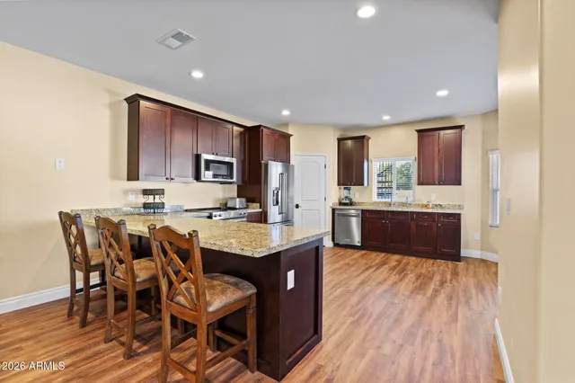 a kitchen with a sink a center island cabinets and a window