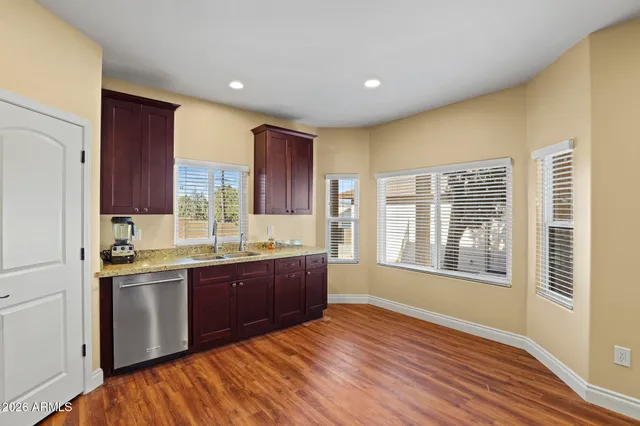 a view of kitchen with wooden floor and electronic appliances