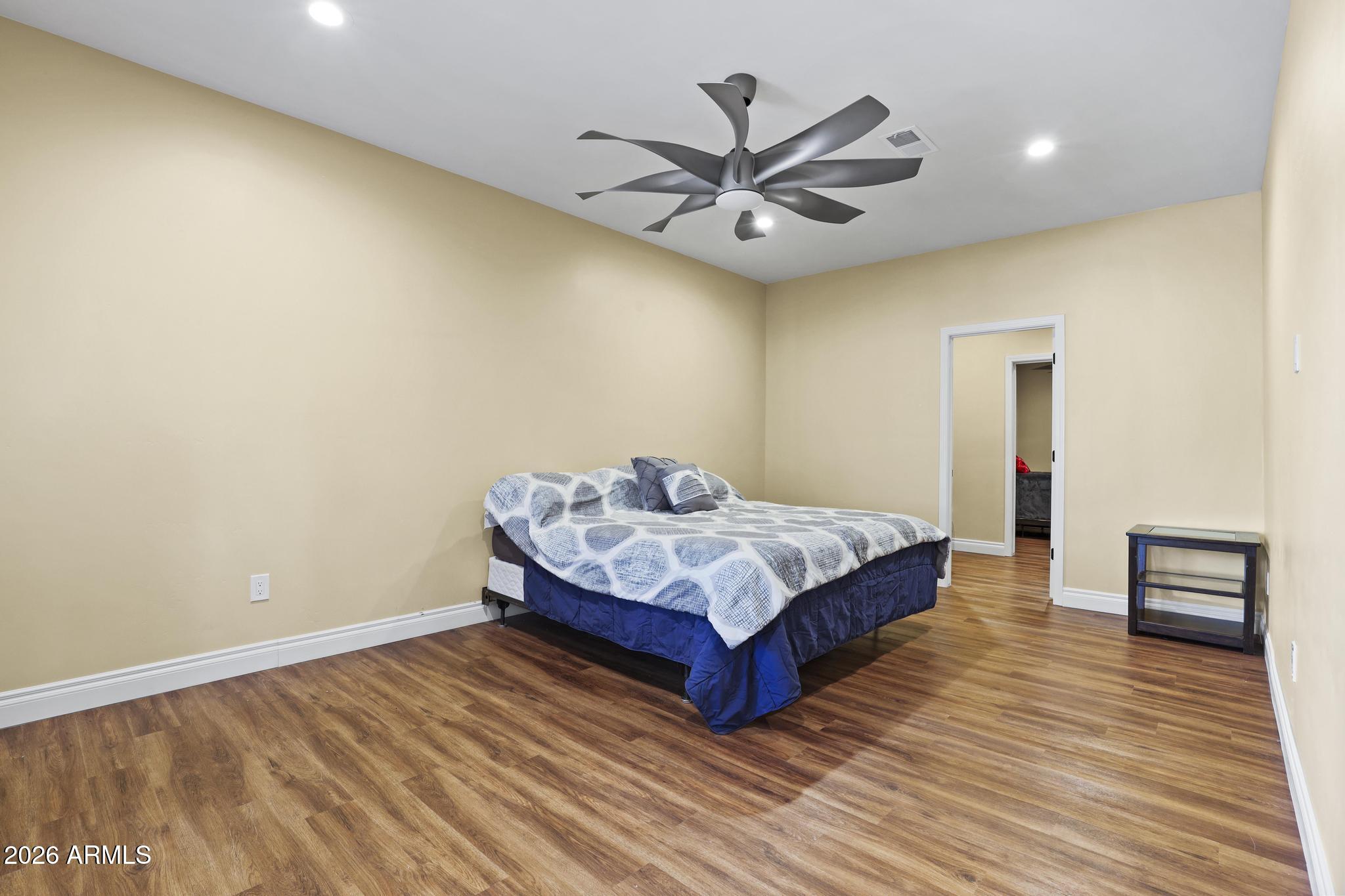 7705 Caballero Road Payson, AZ 85541 - Photo 32 of 43 a bedroom with a bed and a chandelier
