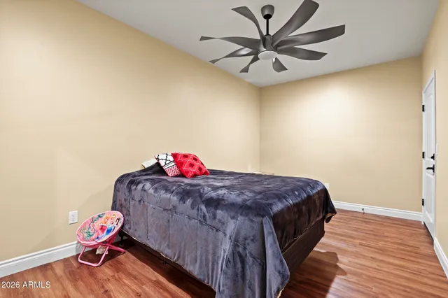 a bed sitting in a bedroom next to a window