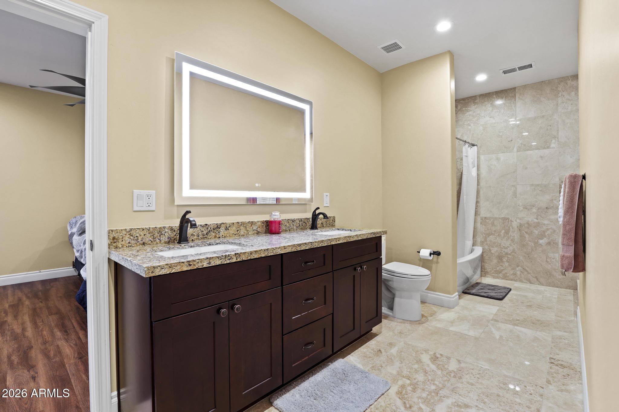 7705 Caballero Road Payson, AZ 85541 - Photo 33 of 43 a bathroom with a granite countertop sink toilet and shower