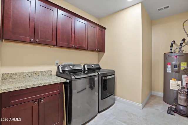a view of a storage and utility room with washer and dryer