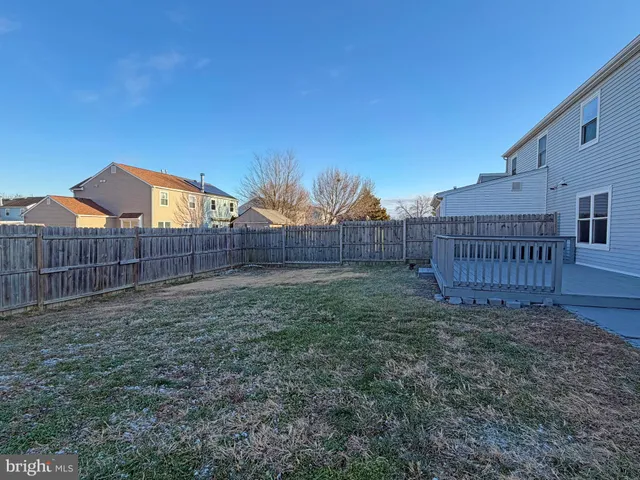 a view of a backyard with wooden fence