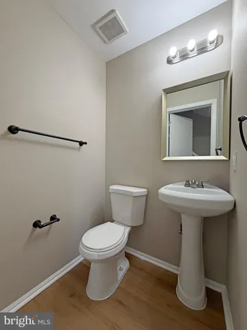 a bathroom with a sink toilet and a mirror
