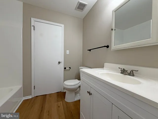 a bathroom with a sink toilet and vanity