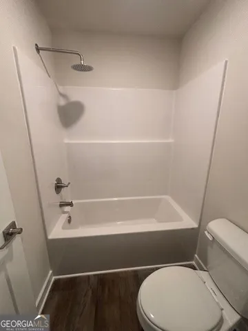 a bathroom with a toilet and a bathtub