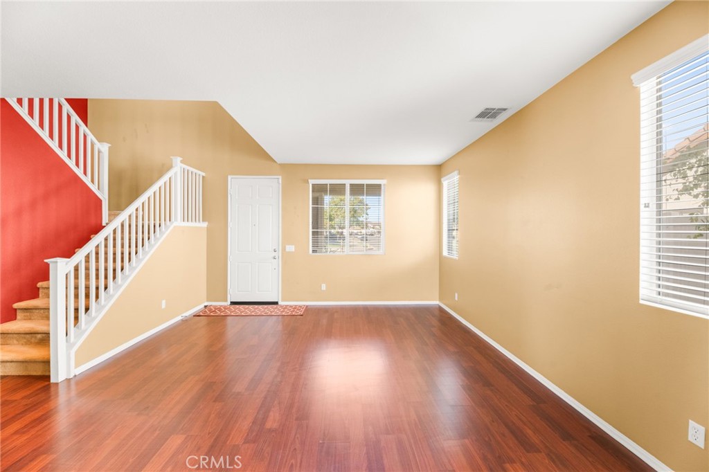 1339 Addison Way Perris, CA 92571 - Photo 11 of 67 a view of an empty room with wooden floor and a window