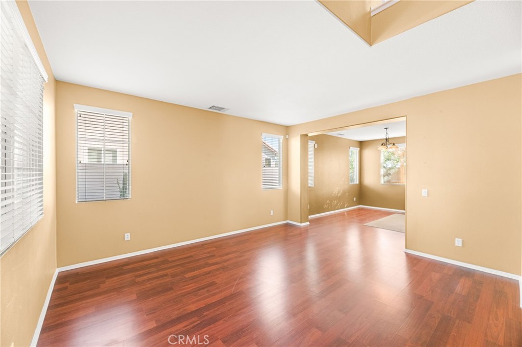 1339 Addison Way Perris, CA 92571 - Photo 16 of 67 a view of an empty room with wooden floor and a window