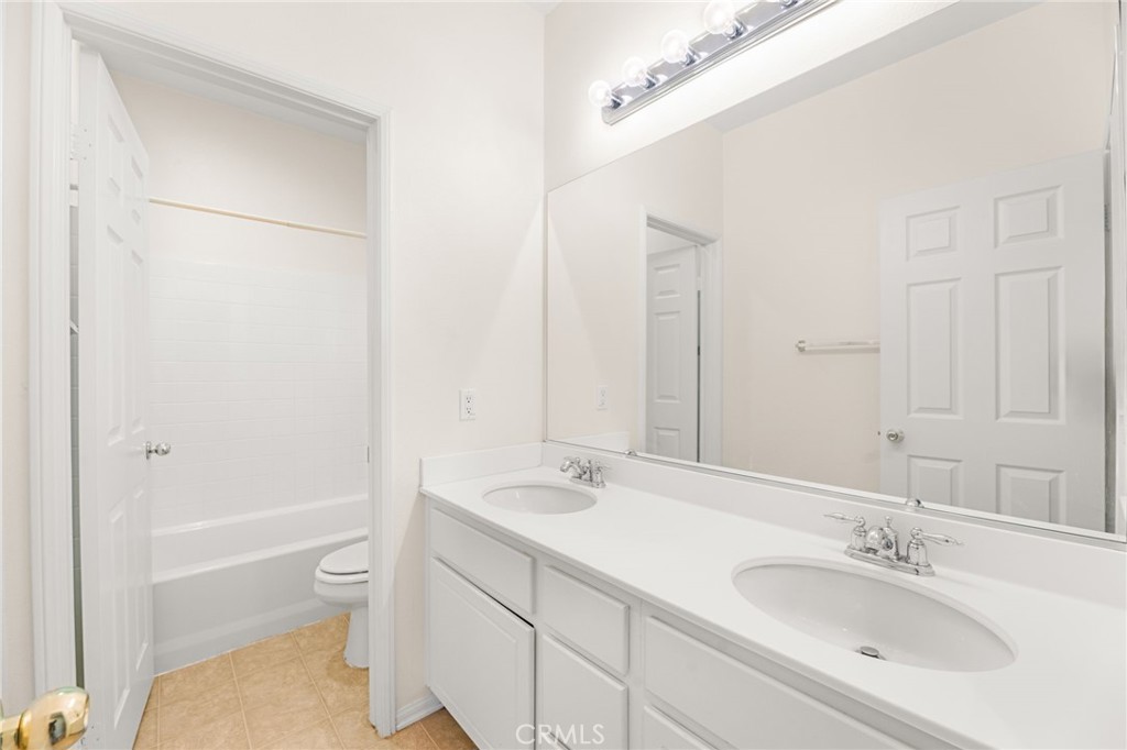 1339 Addison Way Perris, CA 92571 - Photo 42 of 67 a bathroom with a granite countertop sink a toilet and shower