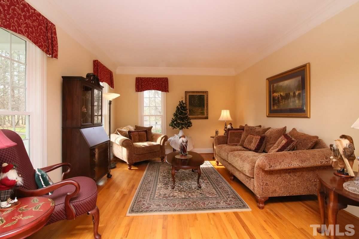 2908 Ballybunion Way Raleigh, NC 27613 - Photo 3 of 25 a living room with furniture wooden floor and a table