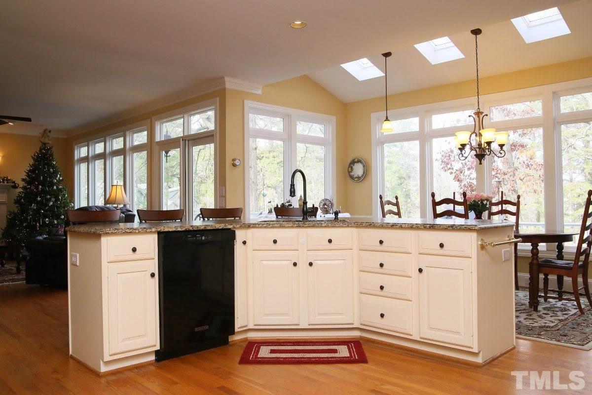 2908 Ballybunion Way Raleigh, NC 27613 - Photo 8 of 25 a large white kitchen with granite countertop a large window and white appliances