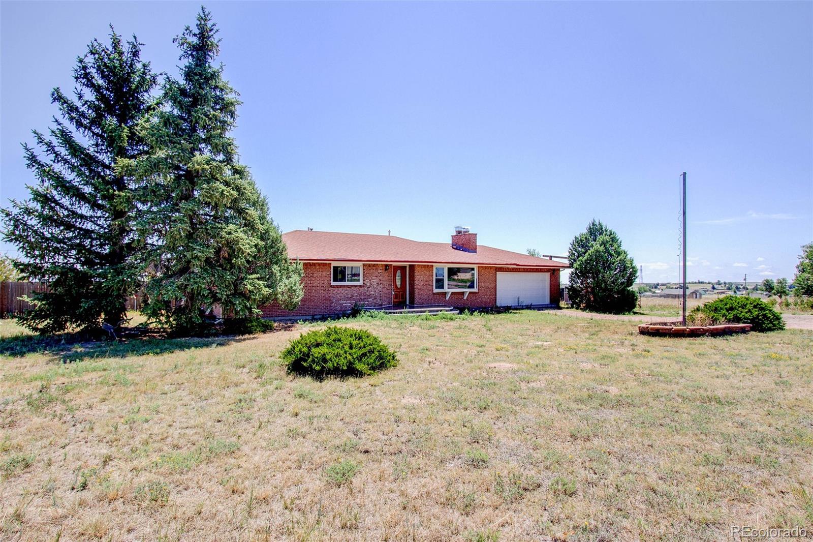 5475 Meridian Road Peyton, CO 80831 - Photo 3 of 35 a view of a house with a yard and a sitting area