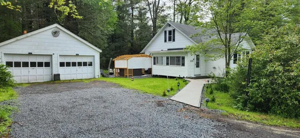 a view of a backyard with swimming pool