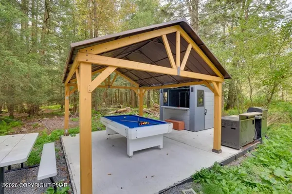 a utility room with dryer washer and a view of living room