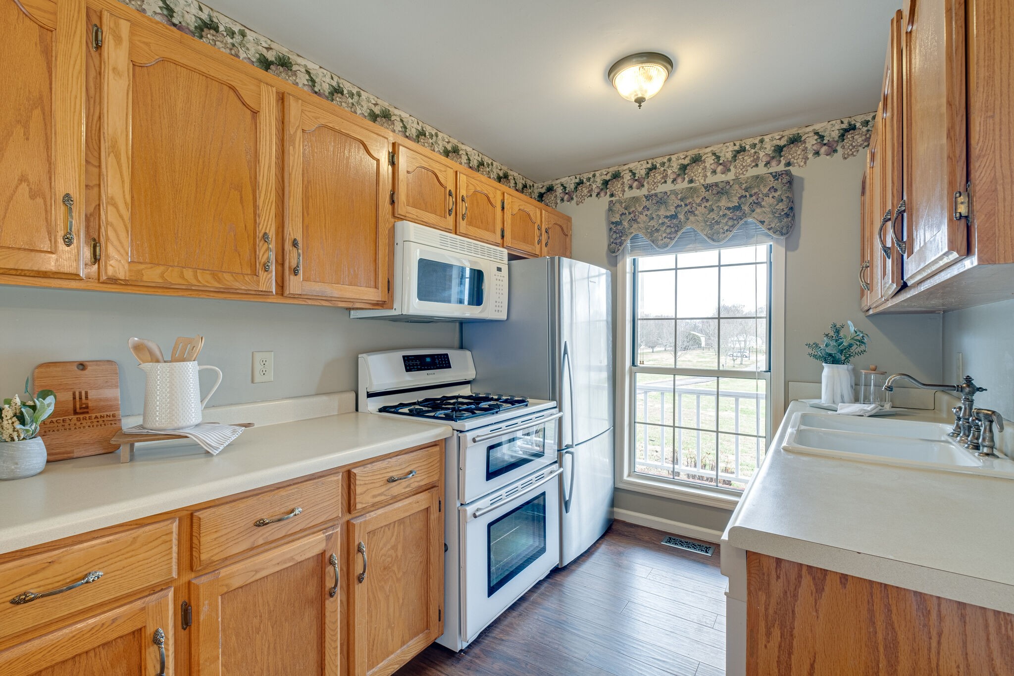 1871 Clara Mathis Road Spring Hill, TN 37174 - Photo 9 of 39 a kitchen with stainless steel appliances granite countertop a sink stove and cabinets