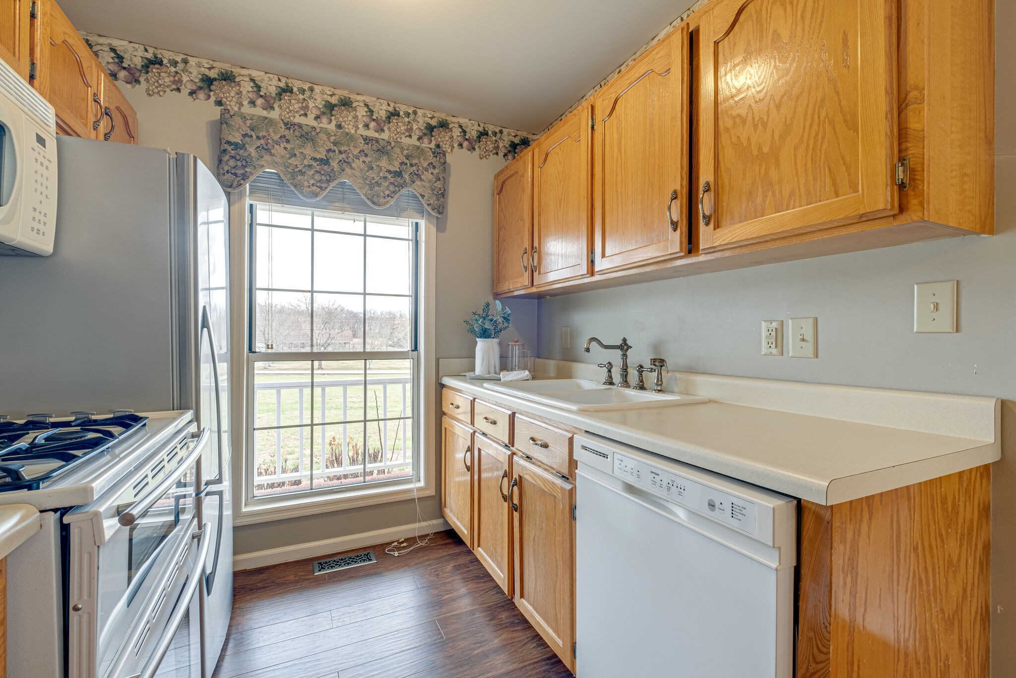 1871 Clara Mathis Road Spring Hill, TN 37174 - Photo 10 of 39 a utility room with stainless steel appliances granite countertop a sink and dishwasher a stove top oven with wooden floor