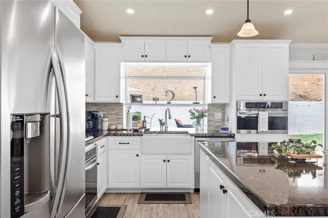 a kitchen with stainless steel appliances a sink stove and refrigerator