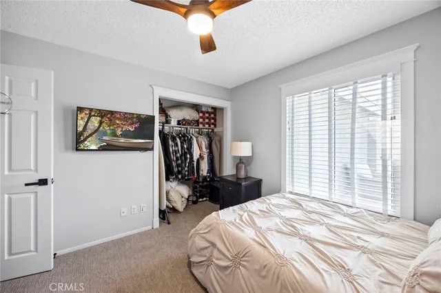 a bedroom with a bed and a painting on the wall