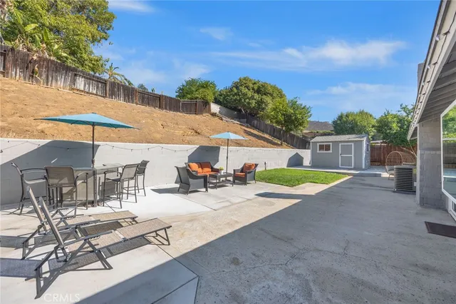 a view of a house with backyard porch and sitting area