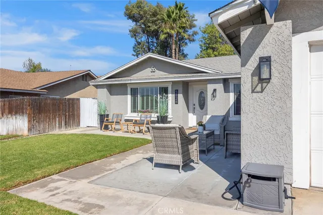 a view of a house with backyard sitting area and garden