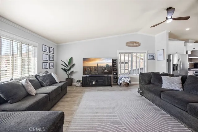 a living room with furniture a large window and a flat screen tv