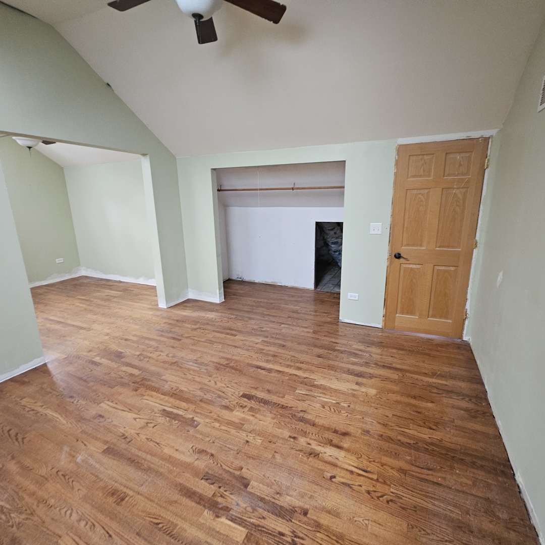 181 Old Sutton Road Barrington, IL 60010 - Photo 17 of 21 a view of an empty room with wooden floor and a window