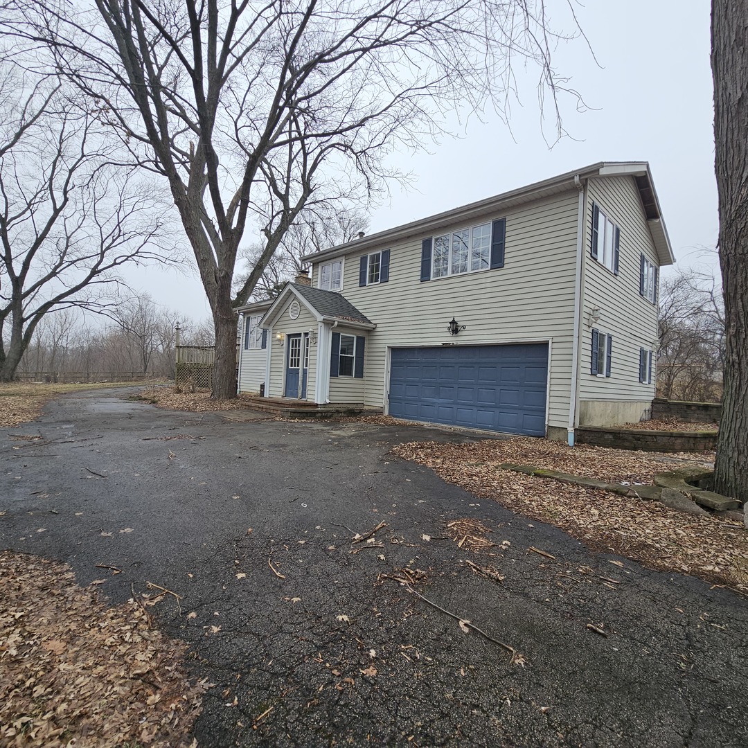 181 Old Sutton Road Barrington, IL 60010 - Photo 3 of 21 a front view of house with yard and trees