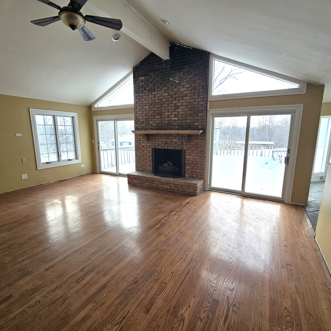 181 Old Sutton Road Barrington, IL 60010 - Photo 7 of 21 wooden floor fireplace and windows in an empty room