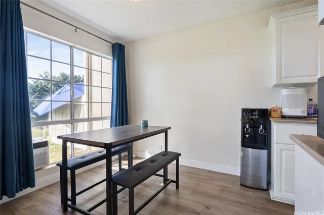 a view of a dining room with furniture window and wooden floor
