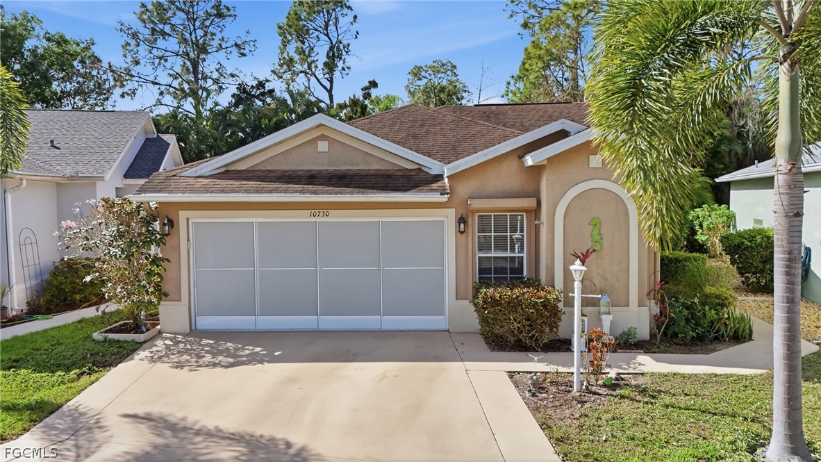 10730 Rio Mar Circle Estero, FL 33928 - Photo 2 of 47 a front view of a house with garden