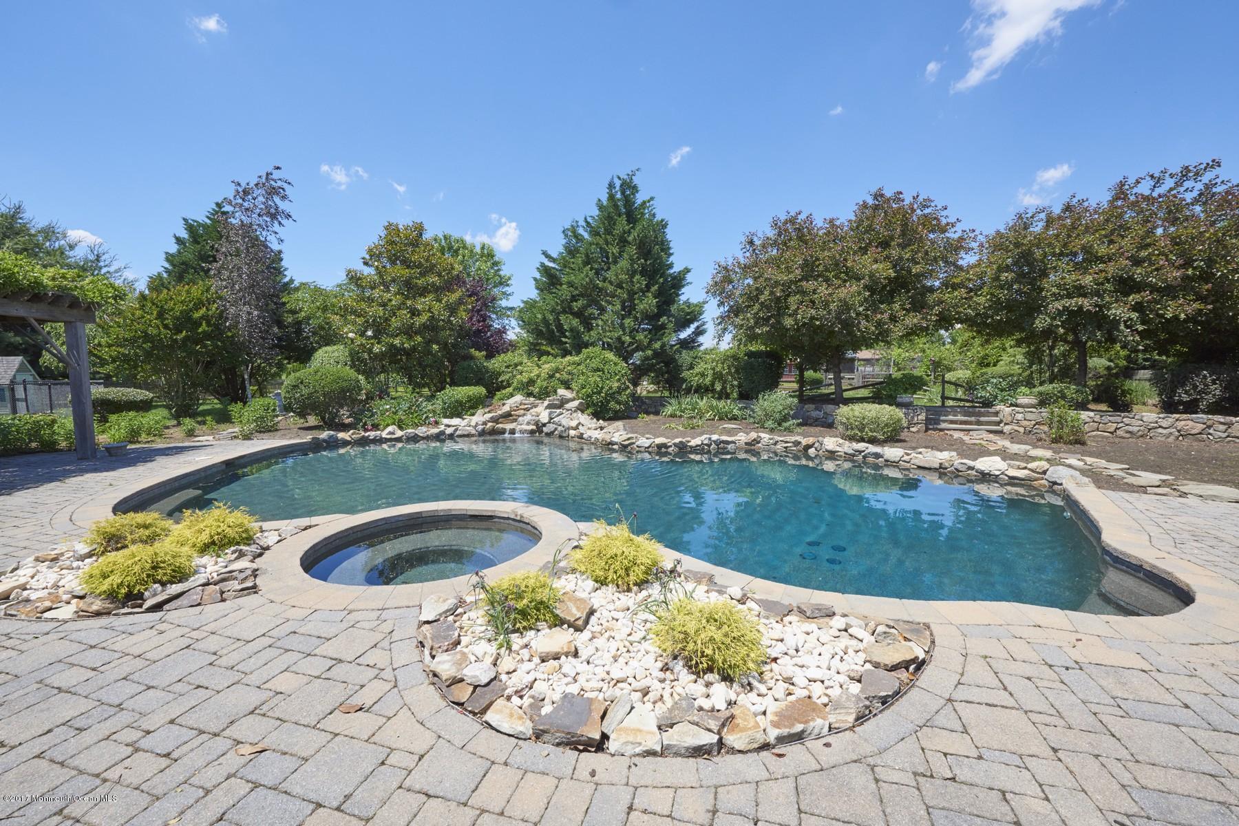 49 Nurko Road Millstone Township, NJ 08535 - Photo 29 of 39 Heated pool with waterfall
