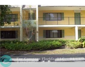 a front view of a building with a garden