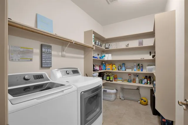 a bedroom with bed and a chandelier