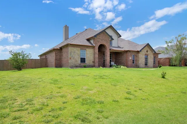 a front view of house with yard and green space